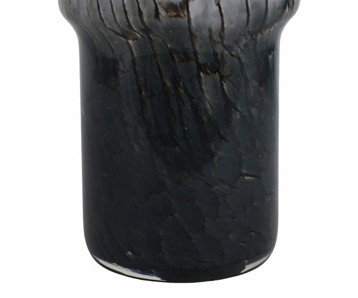 Close-up of the Abstract Vase with Veining: a dark, glossy, cylindrical glass piece featuring a subtly flared rim and textured marbled veining in black with gentle hints of brown. This hand-finished glass vase adds an artisanal touch to any décor.