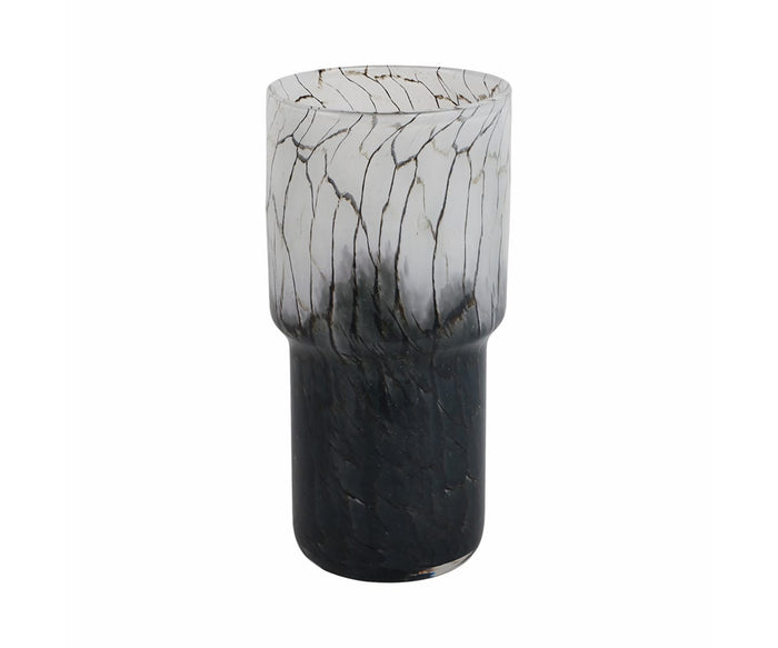 The Abstract Vase with Veining is a tall, cylindrical glass vase showcasing a stunning gradient from clear at the top to deep black at the base. Thin, irregular veining details add visual intrigue, while its hand-finished construction reflects expert craftsmanship, making this piece an eye-catching artistic addition to any space.