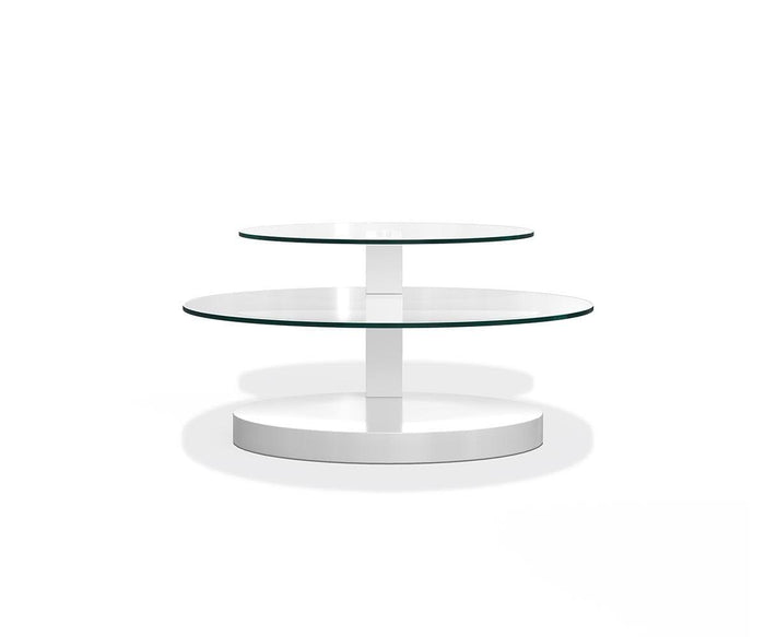 The Adria Coffee Table is a modern, round piece featuring two tiers of tempered glass set atop a central white column and a solid white base, showcasing contemporary design against a plain white background.