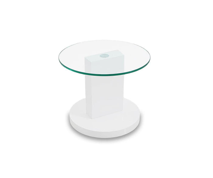 A modern round glass tabletop defines the Adria End Table, showcasing its contemporary design with a central white high gloss rectangular support and a circular white high gloss base, set against a plain white background.