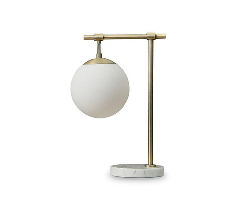 The Aerlig Table Lamp, shown here in Brass-Marble, features a round white glass shade atop a brass-colored metal frame and a circular marble base, all set against a plain white background. This lamp effortlessly combines vintage-inspired elements with modern design for an elegant, timeless appearance.