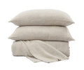 Two Andrea Pillows in Ivory A04 are stacked on top of a folded blanket made from the same fabric, all set against a white background—an ideal addition to your bedroom decor.
