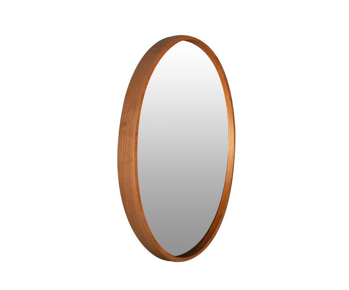 The Baptisia 35″ Round Mirror, shown at an angle against a white background, features a thin wood frame that embodies modern artistry with its sleek and timeless design.