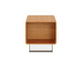 The Baptisia End Table is a small, rectangular wooden table in a CHERRY finish, featuring an open front with no shelves, rounded edges, and a distinctive flat metal base. Its design evokes cubist art sculpture.