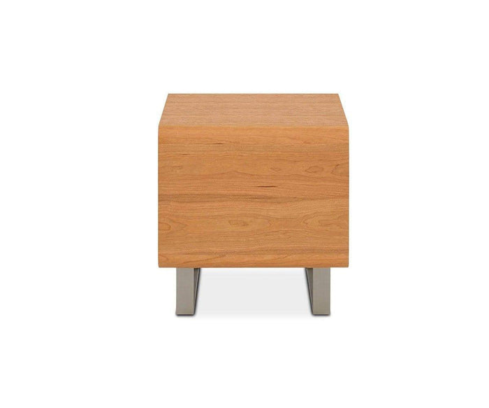 The Baptisia End Table features a square wooden top with a smooth surface and natural wood grain, highlighted by a rich cherry finish. It is supported by two rectangular metal legs that evoke the geometric style of cubist art. The table is displayed against a plain white background.