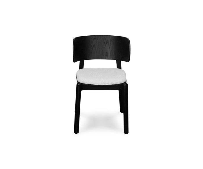 The Beau Chair is a modern wooden dining chair in black, featuring a curved backrest and an upholstered cushioned seat, shown against a plain white background.