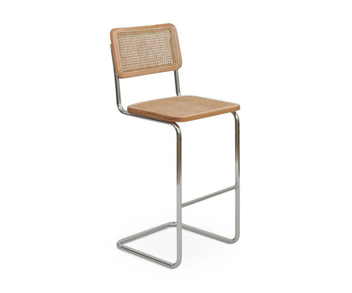 Introducing the Bendt Bar Stool, a modern cane bar stool featuring a chrome cantilever base, a cane woven seat, and a matching cane backrest beautifully framed in light European beech wood.