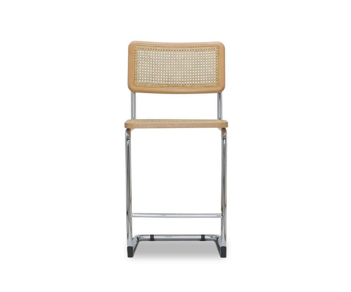 Introducing the Bendt Counter Stool in Bendt Natural—a modern, minimalist counter stool featuring a light wood cane seat and backrest, supported by a sleek metal frame. This mid-century inspired design showcases clean straight lines and a natural finish for an elevated yet timeless look.