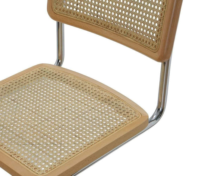 A close-up of the Bendt Counter Stool, featuring a woven cane seat and backrest framed in light wood, supported by a shiny metal tubular base.