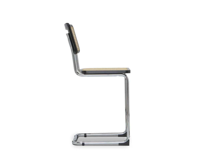 A side view of the Bendt Counter Stool, showcasing its cantilevered chrome frame, wooden seat, and mid-century wooden backrest with a distinctive woven pattern.