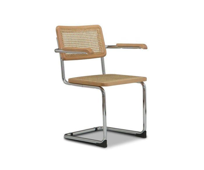 The Bendt Dining Armchair features a chrome cantilever frame, modern beech wood construction, woven cane backrest and seat, and smooth wooden armrests. Set against a plain white background, this elegant dining chair effortlessly captures mid-century style while blending natural textures with contemporary design.