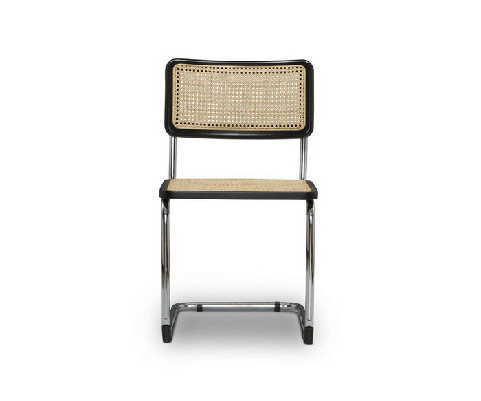 The Bendt Dining Chair in BENDT NATURAL/BLACK features a modern design with a cane woven backrest and seat, black frame, and chrome metal legs, shown against a plain white background.