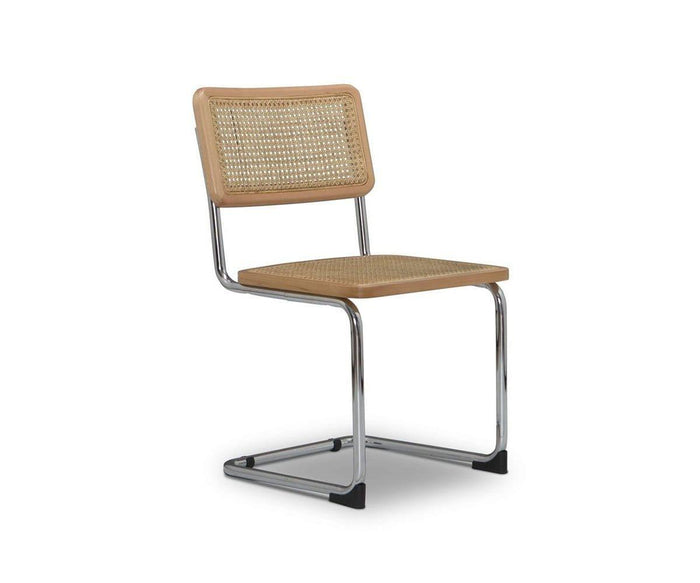 The Bendt Dining Chair features a cantilever chrome metal frame, a woven cane backrest, and a matching cane seat, showcased against a plain white background.