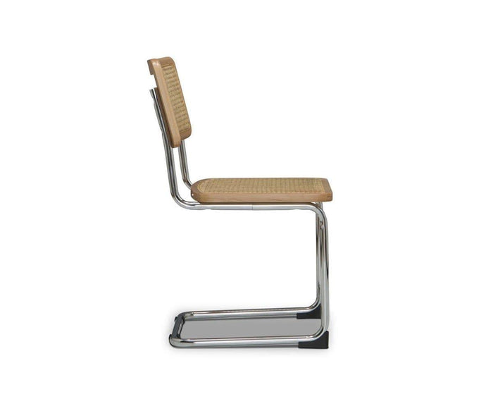 Side view of the Bendt Dining Chair, featuring a modern mid-century design with a chrome cantilever frame, woven cane seat and backrest, and light beech wood edging, set against a plain white background.