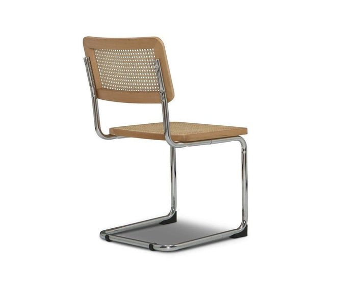 The Bendt Dining Chair is a modern dining chair with a chrome cantilever frame, light wood seat and backrest featuring a woven cane panel, shown from the back against a white background.