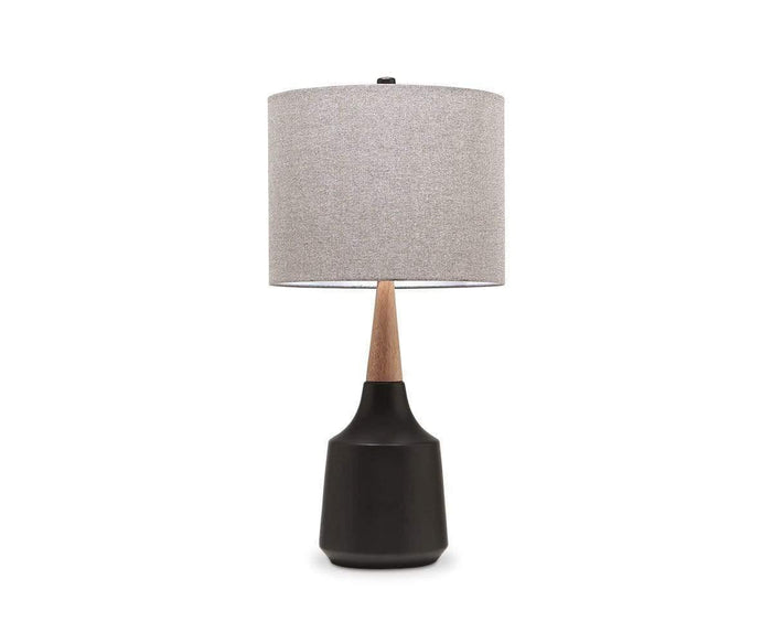 The Bergset Table Lamp showcases a black/multi ceramic base with bold geometric lines, a wooden neck, and a chic grey fabric drum shade, set against a plain white background.