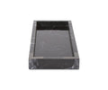 The Black Mirrored Marble Tray, shown in a rectangular form and viewed from a low front angle against a plain white background, showcases its elegant black color with striking white veining. The sophisticated tray’s allure is further accentuated by subtle brushed titanium accents along its edges.