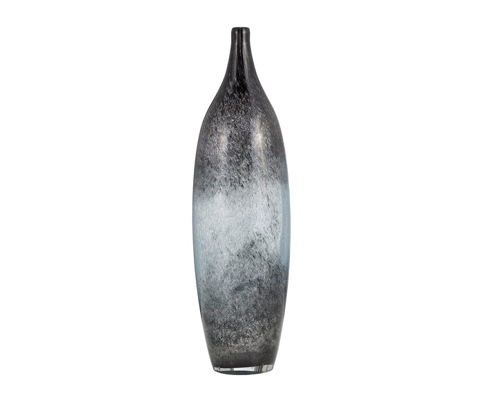 The Blue Nebula Vase features a tall, slender ceramic design with a narrow neck. Its surface displays a captivating blue ombre gradient, transitioning from deep gray at the top and bottom to a lighter grayish-white hue in the center. The vase is set against a plain white background.
