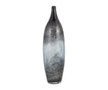 The Blue Nebula Vase features a tall, slender ceramic design with a narrow neck. Its surface displays a captivating blue ombre gradient, transitioning from deep gray at the top and bottom to a lighter grayish-white hue in the center. The vase is set against a plain white background.