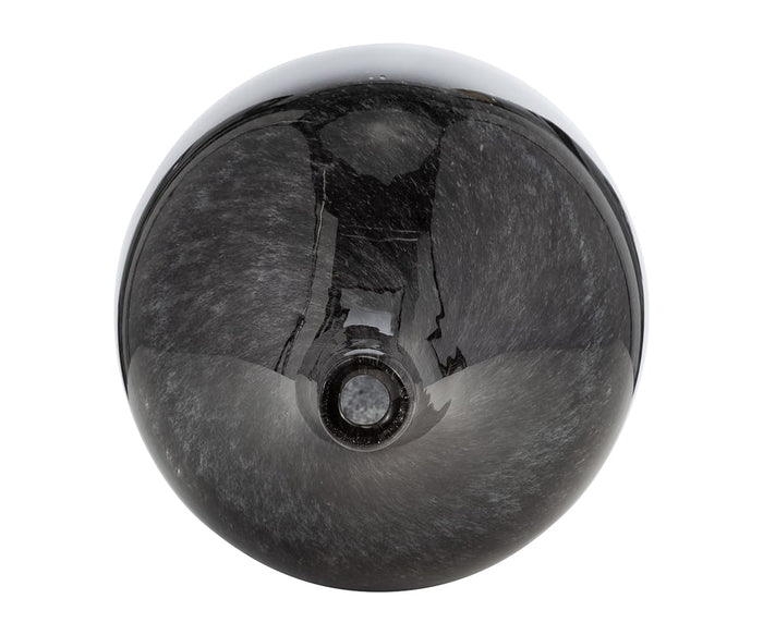 A top view of a shiny, dark gray spherical object with a small circular opening in the center, its smooth surface catching reflections—evoking the meticulous craftsmanship of the hand-finished Blue Nebula Vase.