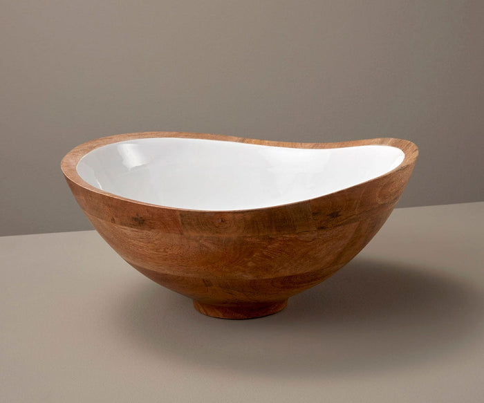 The Bright Bowl, crafted from mango wood, features a large, asymmetrical silhouette with a smooth, polished exterior and a glossy white interior. It sits on a neutral surface against a beige background, exemplifying sustainable home decor through its elegant, handcrafted serveware design.