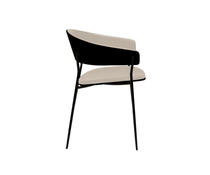The Crib Leather Dining Chair showcases a modern contemporary design with slim black metal legs, a curved black backrest, and a white padded seat, presented from a rear side angle on a white background.