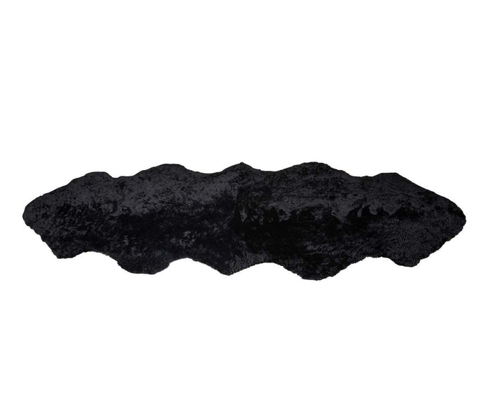 A Curly Double Pelt - Black faux fur rug with a large, irregular animal hide shape and a soft, textured surface reminiscent of a sheepskin throw, displayed against a white background.