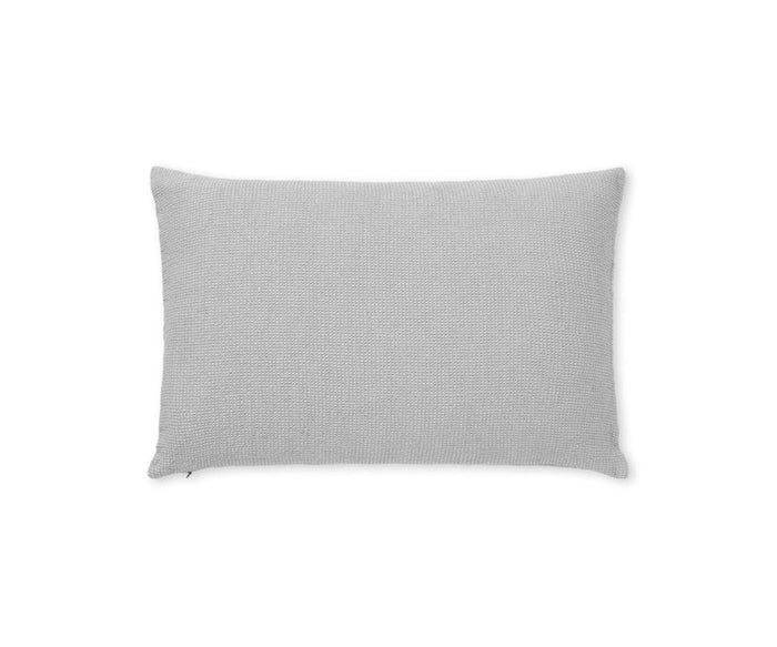 Introducing the Daisy Cushion Cover in Daisy Gray—a rectangular pillow case featuring a textured, knitted fabric. Shown against a plain white background, this cover is crafted from organic cotton to offer both comfort and sustainability.