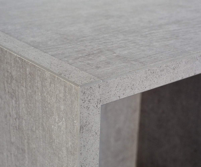Close-up of the corner of a rectangular, gray, textured shelf with a modern, minimalist design and a stylish faux-cement finish. Perfect for eco-friendly storage or pairing with Danne Wall Cubes to complete your contemporary space.
