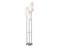 The Daphne Shelf Floor Lamp in brushed steel features three tall, cylindrical white lampshades arranged at different heights on sleek metal rods. A small circular glass shelf at the center provides both style and function to this contemporary floor lamp.