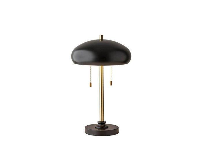Introducing the Darius Table Lamp in Gold/Black, featuring a modern mid-century design with a round black metal shade, sleek gold vertical stem, and a sturdy black circular base. Equipped with two pull chains, this lamp is pictured on a white background and is perfect as an office desk lamp for contemporary workspaces.