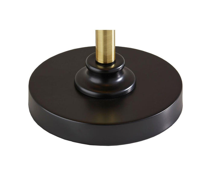 A close-up of the Darius Table Lamp’s round, black base with a gold-colored pole rising from the center, set against a white background—a striking mid-century table lamp that brings timeless elegance to any space.