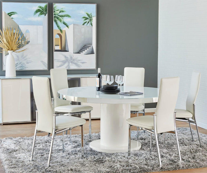 Modern dining room with a round white table, four white chairs, a gray shag rug, wine glasses, plates, and wall art featuring the Distant Escape II Oil Painting depicting palm trees and tropical cityscape architecture in the background.