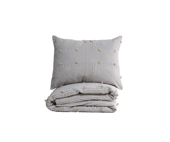 A folded grey Dobby Linework Duvet Cover with a matching sham, both showcasing a subtle square stitched pattern and small tufted accents that highlight artisanal craftsmanship, displayed against a white background.