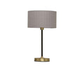 The Doren Table Lamp is a modern lamp featuring a brass finish, a cylindrical gray fabric shade, a slender black stand, and a round base, set against a white background.