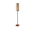 The Dusk Floor Lamp features a cylindrical taupe fabric shade, a slender black metal pole, and a square walnut base. Shown illuminated against a plain white background, this tall lamp adds an elegant touch that perfectly complements mid-century decor.