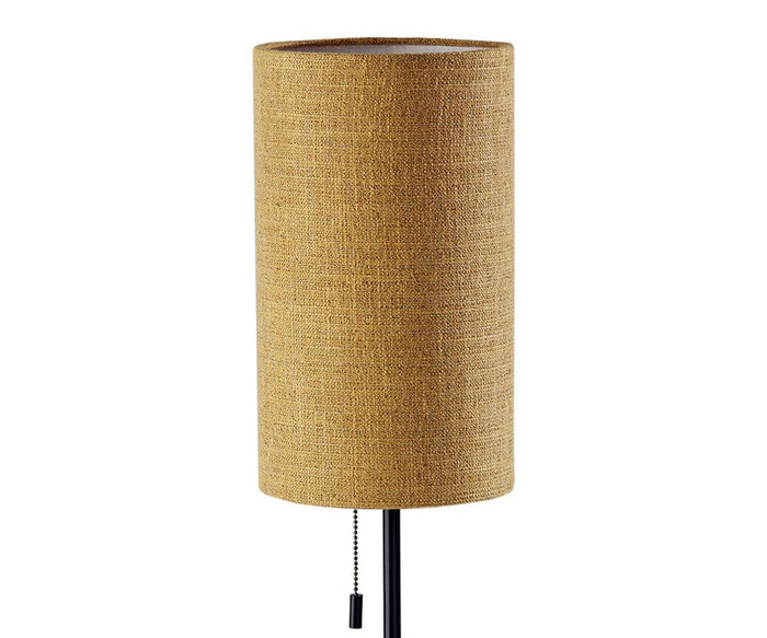 The Dusk Table Lamp features a brown cylindrical lampshade with a textured fabric surface atop a sleek walnut base, complete with a hanging pull chain for easy on or off—making it the perfect stylish accent for any mid-century decor.