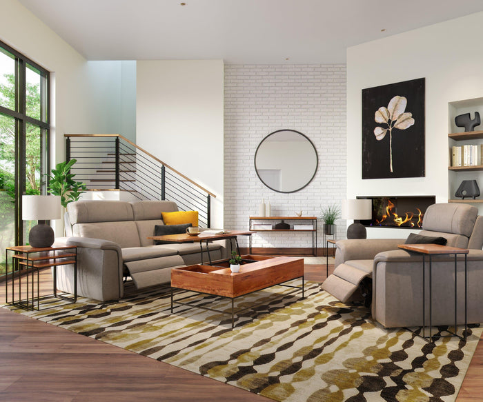 Modern living room with beige sofas, a wooden coffee table, a patterned rug, two side tables—one featuring the Earthenware Jug Lamp—alongside a round mirror on a white brick wall, fireplace, built-in shelves, and large windows letting in natural light.