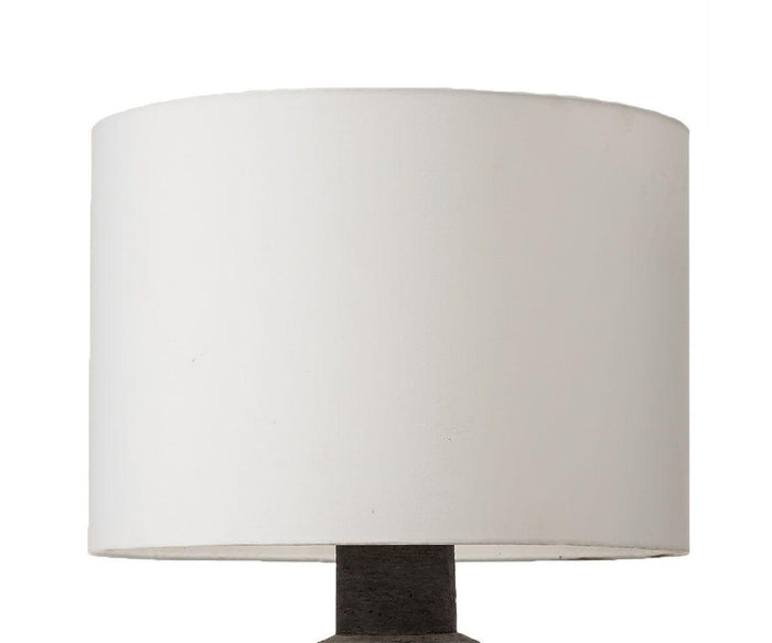 A close-up of the Earthenware Jug Lamp, featuring a white cylindrical rattan lampshade atop a dark earthenware base, set against a plain white background.