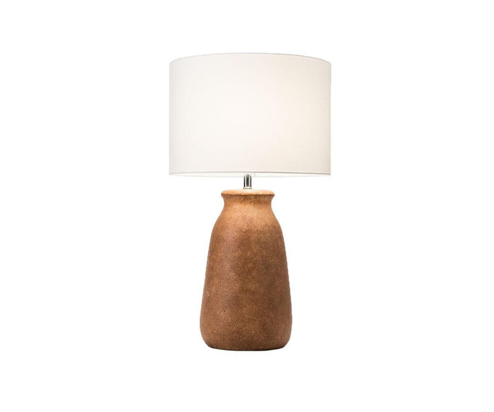The Earthy Luster Lamp features a textured, matte-finished brown ceramic base paired with a large cylindrical white lampshade. Its simple and modern design embodies understated elegance, showcased here against a plain white background.
