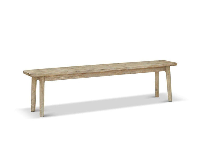 The Eckler Bench, a simple and long grey wood bench with four legs crafted from solid acacia wood, is shown on a white background.