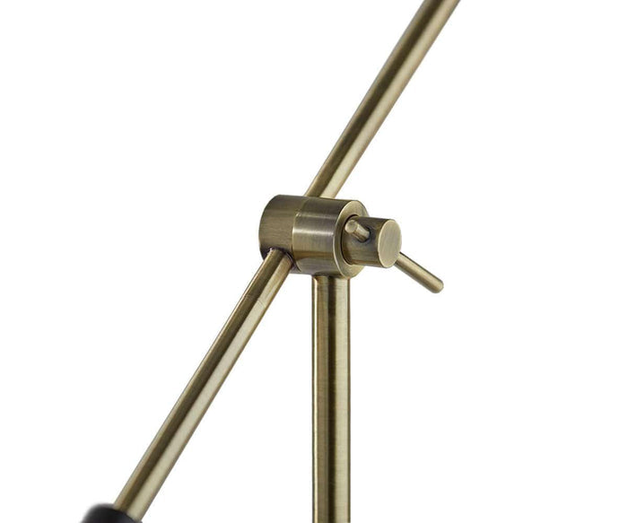 A close-up of the brushed brass joint mechanism connecting two metal rods at an angle, with a small horizontal lever attached to the joint—highlighting the precise engineering of the Eden Task Lamp’s modern design.