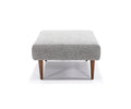 A square Ella Ottoman in Grey 538, featuring upholstery and wooden tapered legs inspired by mid-century modern design, displayed against a white background.