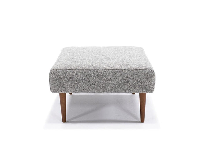 A square Ella Ottoman in Grey 538, featuring upholstery and wooden tapered legs inspired by mid-century modern design, displayed against a white background.