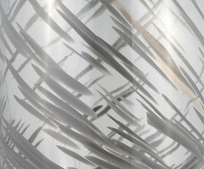 Close-up of the Etched Lattice Vase’s metallic surface, featuring abstract, diagonal dark streaks and reflections that form a dynamic, textured pattern reminiscent of the intricate detailing found on hand-finished glass accent pieces.