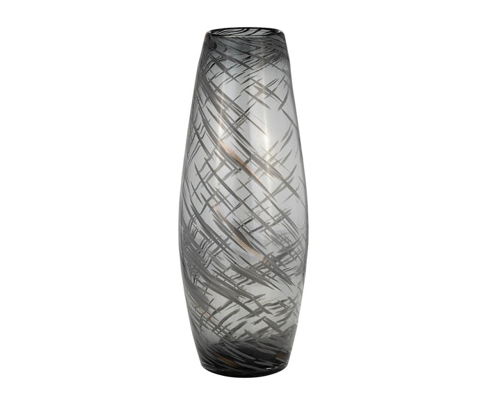 The Etched Lattice Vase is a tall, cylindrical piece crafted from hand-finished glass with a smoky gray tint, adorned with abstract crisscrossed black line patterns—making it an elegant accent for any modern space.