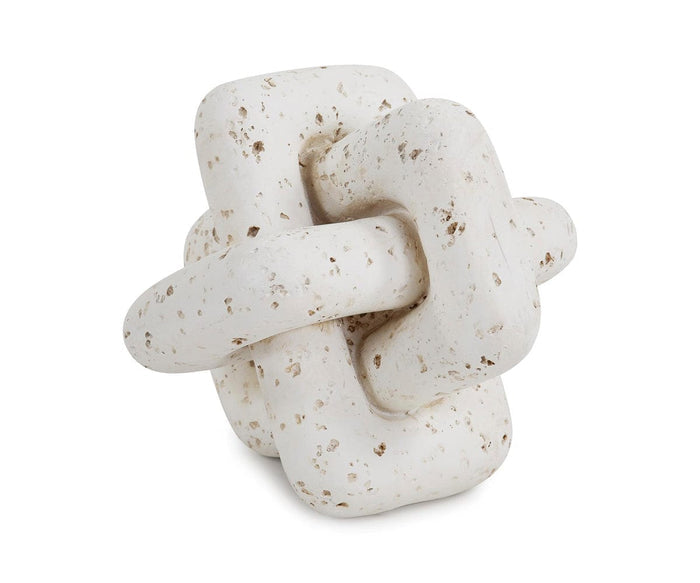 The Everlink Sculpture is a white, speckled ceramic piece featuring two interlocking, abstract geometric forms set against a plain white background, with a travertine-like texture that evokes the look of natural stone carving.