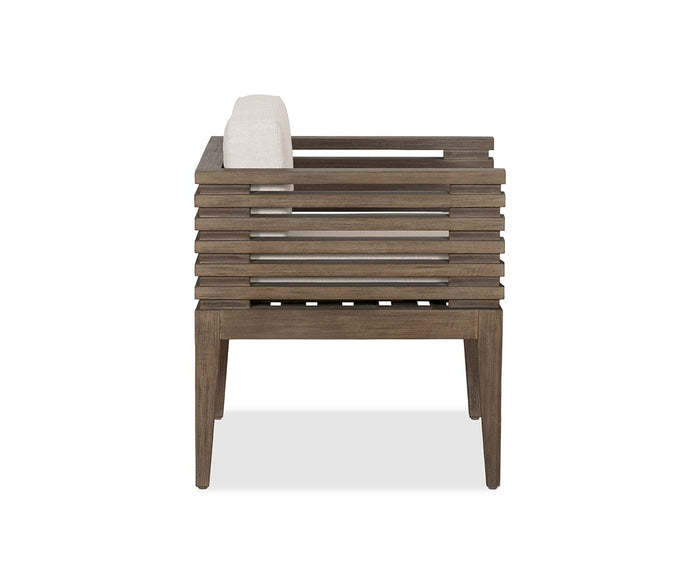 Side view of the Farren Outdoor Dining Chair, featuring horizontal wooden slats and a light-colored cushioned backrest, set against a white background—an elegant patio furniture piece tailored for comfortable outdoor dining.