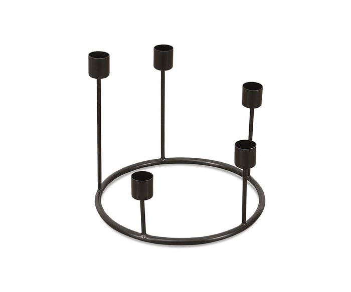 The Fina Candle Wreath is a black metal candle holder featuring five evenly spaced upright holders around a circular base, handcrafted in India for a striking decorative touch.