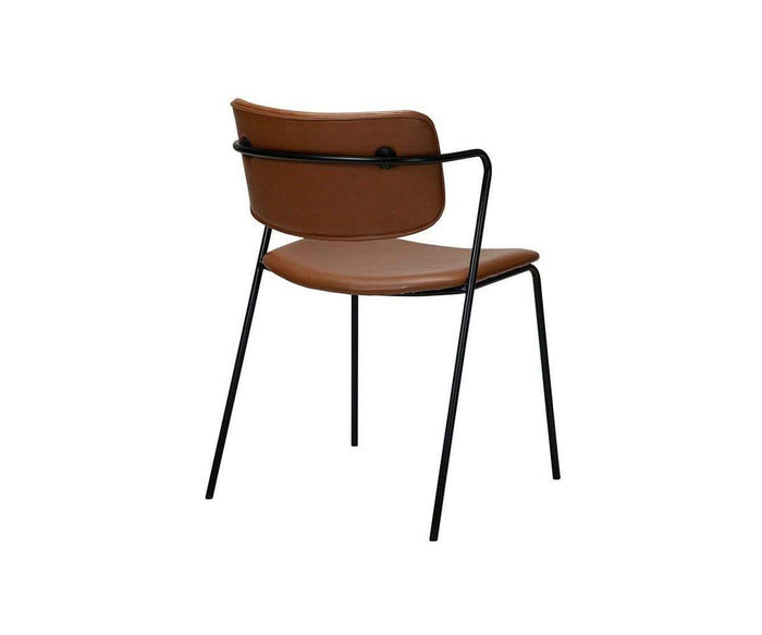 The Finn Dining Chair showcases a contemporary design with a curved brown leather seat and backrest, supported by slender black metal legs and frame, as displayed from an angled rear view.